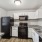 Black appliances with white cabinets inside kitchen